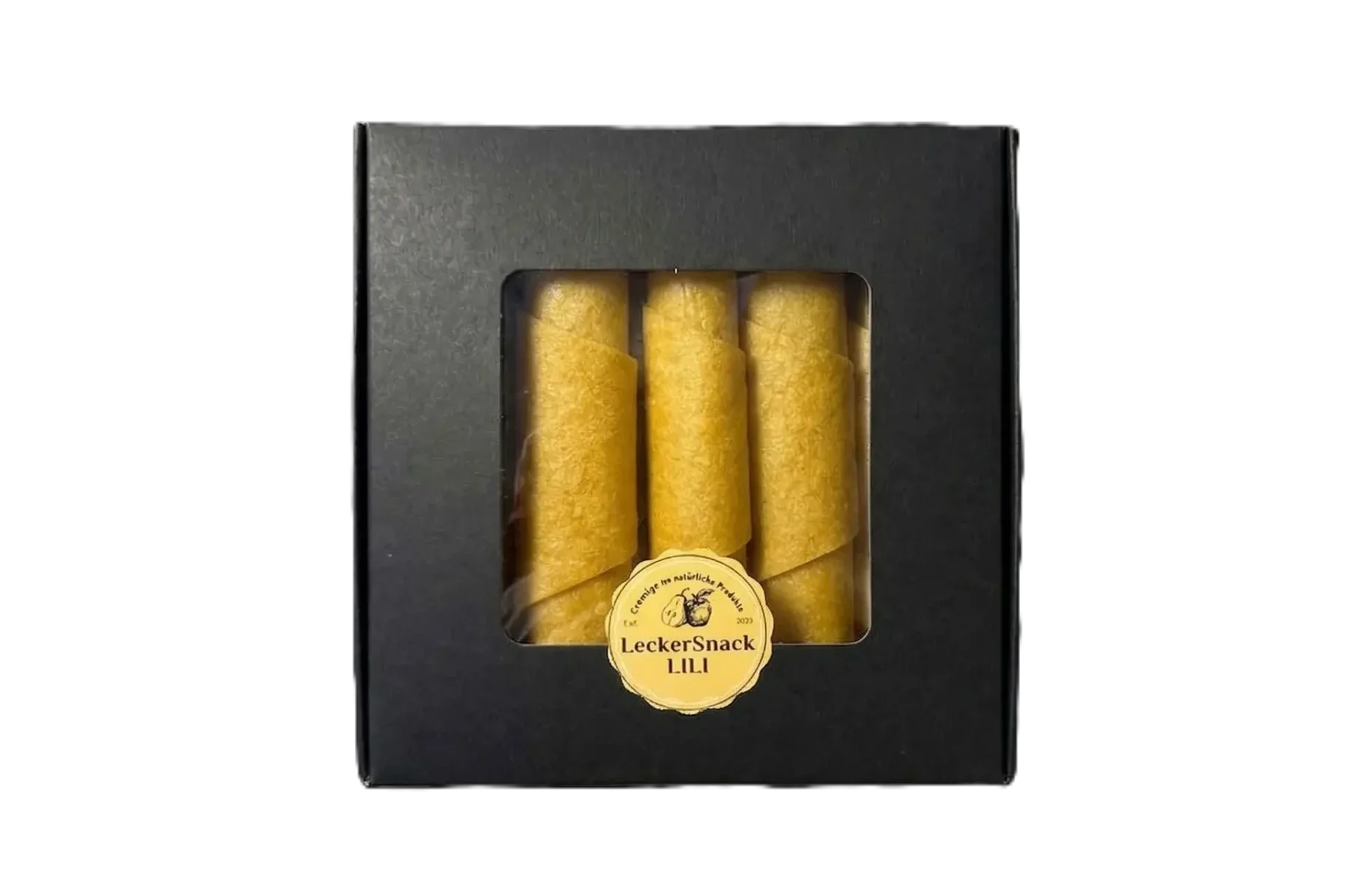 Schwarze Fensterbox mit leuchtend orangen Fruchtleder-Rollen und rundem LeckerSnack Lili Siegel.