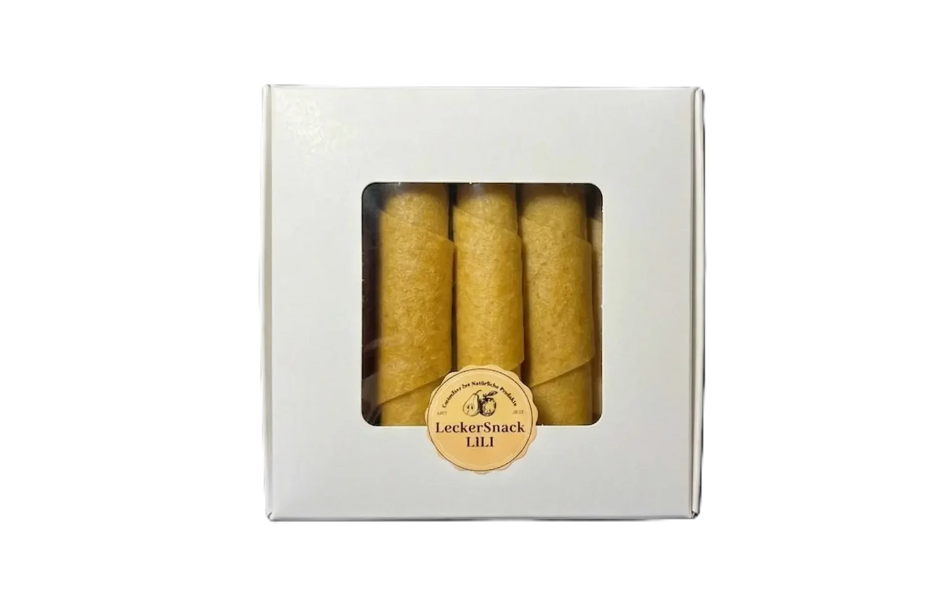 Weiße Fensterbox mit leuchtend orangen Fruchtleder-Rollen und rundem LeckerSnack Lili Siegel.